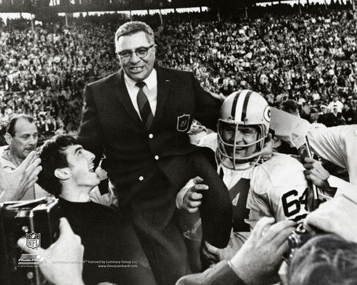 Packer coach Vince Lombardi is all grins as players start to lift